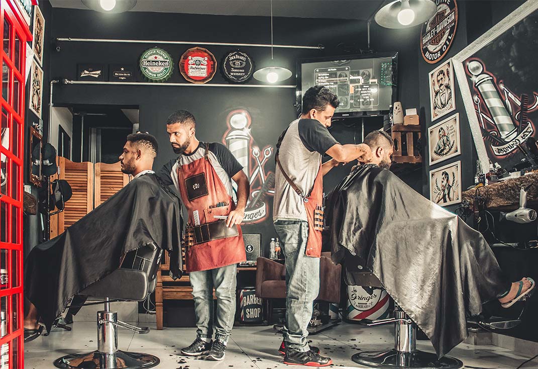 Two customers attended in a barbershop